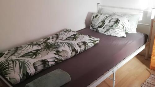 a bed with two pillows on top of it at Haus Lindheim in Altenstadt