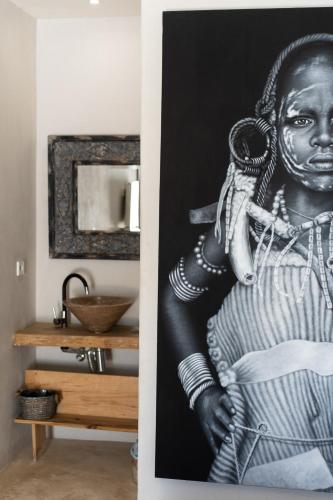 a black and white photo of a woman on a wall at Boho Suites Denia in Denia