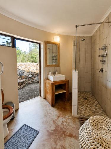 a bathroom with a sink and a shower at Palala River Cottages in Vaalwater
