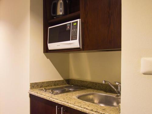 a kitchen with a sink and a microwave at Porto Sharm Elshiekh Vacation Hotel in Sharm El Sheikh