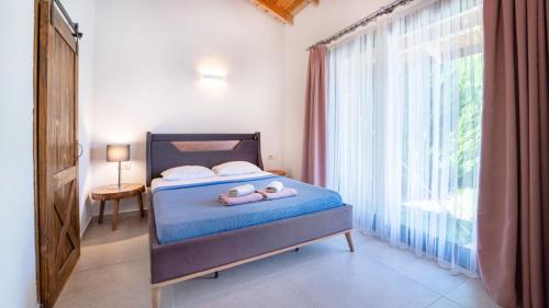a bedroom with a bed with two stuffed animals on it at Villa Lagerta in Kayakoy