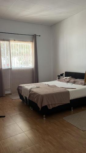 a bedroom with a large bed in a room at Nirvana camp in Matola
