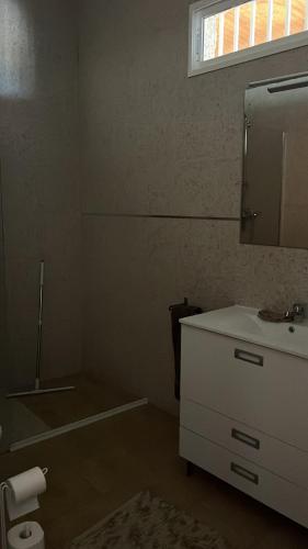 a bathroom with a sink and a mirror at Nirvana camp in Matola