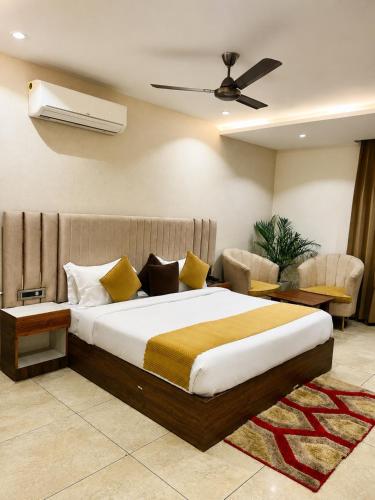 a bedroom with a large bed and a couch at Hotel Emience in Chandīgarh