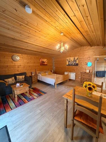 a large room with a bed and a couch and a table at Rife Lodges in Arundel