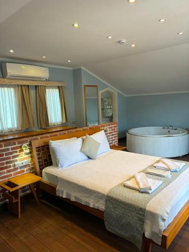 a bedroom with a bed and a bath tub at Kaya Amari in Fethiye