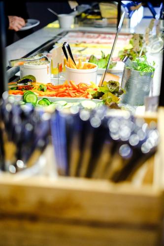 a buffet with a lot of food on a table at Home Hotel Temperance in Malmö