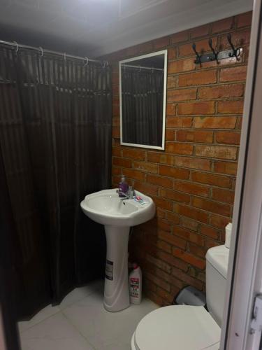 a bathroom with a sink and a brick wall at Giorgi in Poti