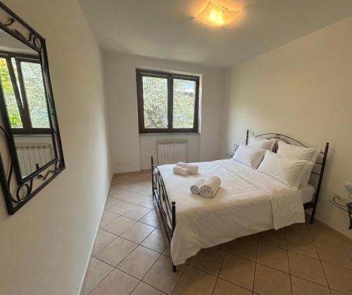 a bedroom with a bed with towels on it at Dolce Vita LakeView - By Turidea in Sale Marasino