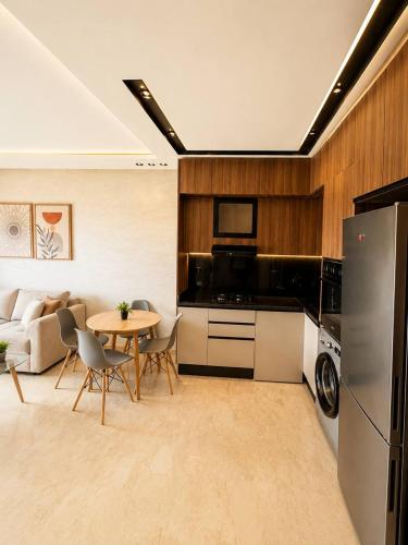 a kitchen and living room with a table and a refrigerator at Premium studio Casablanca in Maarif