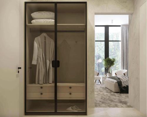 a wardrobe with a suit in a bedroom at Vinárstvo Jurovčík in Lošonec