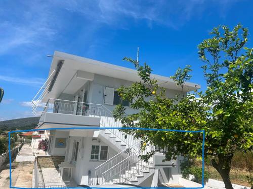a white building with stairs and a tree at Filio's home in Zárakes