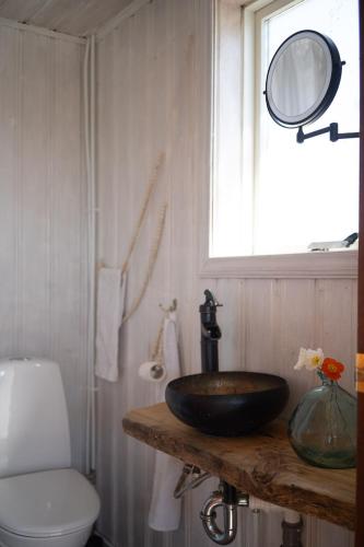 a bathroom with a sink and a toilet and a window at Solhaven in Selfoss