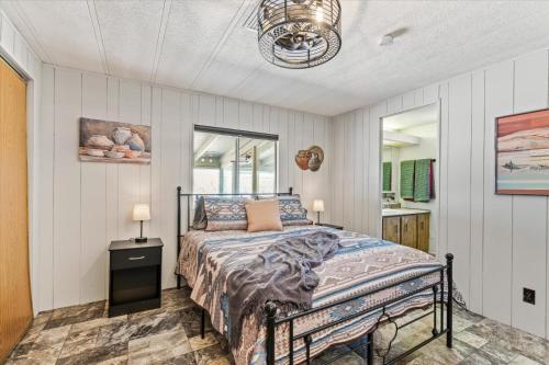 a bedroom with a bed and a bathroom with a mirror at Cozy Desert Hideaway in Tucson