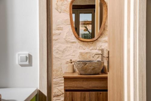 a bathroom with a sink and a mirror at Casa Falco in Vasilikos
