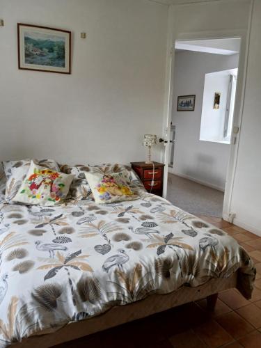 a bed with a comforter with birds on it at Studio in Pontacq