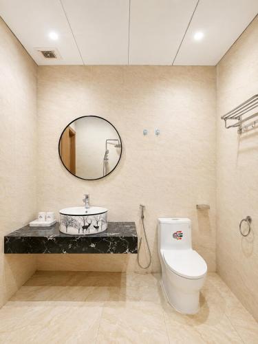 a bathroom with a toilet and a mirror at Maro Hotel & Apartment in Nha Trang