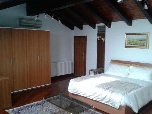 a bedroom with a bed and a glass table at Alle Grazie in Casièr
