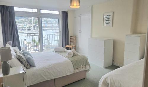 a bedroom with a bed and a large window at Riverside 2 in Dartmouth