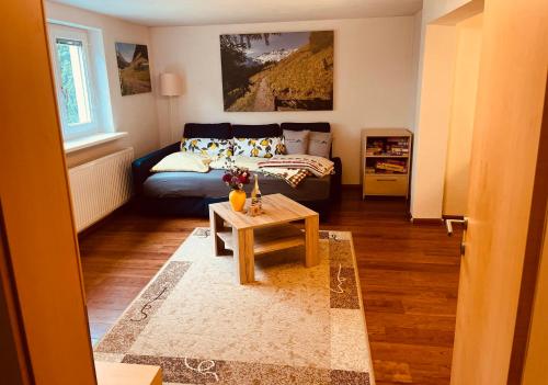 a living room with a couch and a table at Ferienwohnung Glusavinahüsle in Vandans