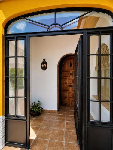 an entry to a house with a glass door at Aromas del Raposo in Puebla de Sancho Pérez