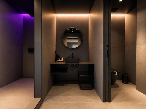 a bathroom with a sink and a mirror at Agarthi Suites in Piateda