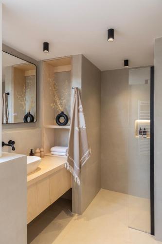 a bathroom with a sink and a mirror at Eks Mani Peninsula Retreat in Pirgos