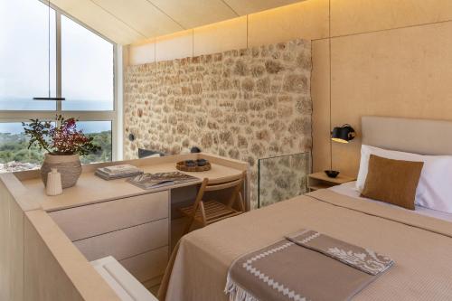 a bedroom with a bed and a desk and a window at Eks Mani Peninsula Retreat in Pirgos