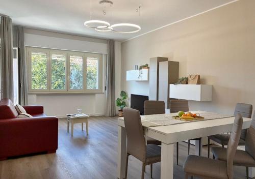 a dining room and living room with a table and chairs at Holihome - LUNA in Tortoreto Lido