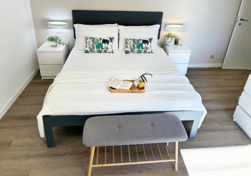 a bedroom with a large bed with a book on it at Holihome - LUNA in Tortoreto Lido
