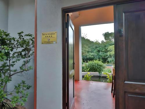 an open door with a sign on the wall at Ambience Inn White River in White River