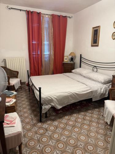 a bedroom with two beds and red curtains at Residence Della Corte in Tocco da Casauria