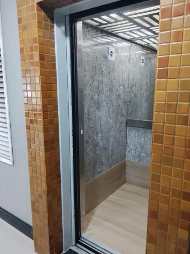 a glass shower door in a room with at Tulipa Hotel in Foz do Iguaçu