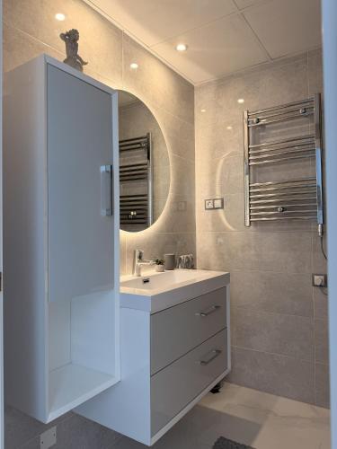 a bathroom with a white sink and a mirror at Infinity View apartment in Arenales del Sol
