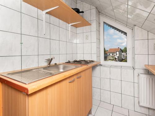 a kitchen with a sink and a window at Martina in Stegna