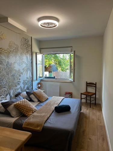 a bedroom with two beds and a window at Ecrin de Verdure Spa, Piscine et Nature in Angrie
