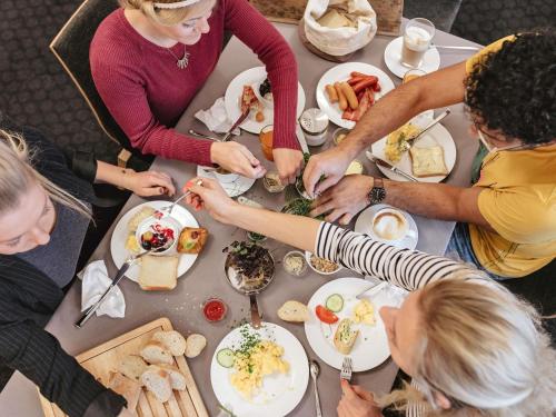 a group of people sitting around a table eating food at Hotel Ibis Coimbra Centro in Coimbra