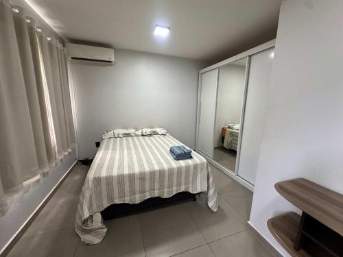 a bedroom with a bed with a striped blanket at Ape do lado do ginasio lago faculdades e mercados in Toledo
