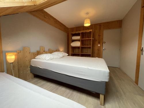 a bedroom with a bed and a book shelf at Appartement le bouc in Albepierre-Bredons