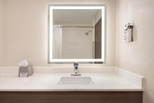 a bathroom with a white sink and a mirror at Holiday Inn Express Morgantown by IHG in Morgantown