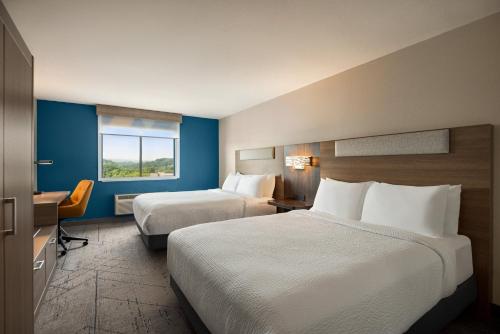 a hotel room with two beds and a window at Holiday Inn Express Morgantown by IHG in Morgantown