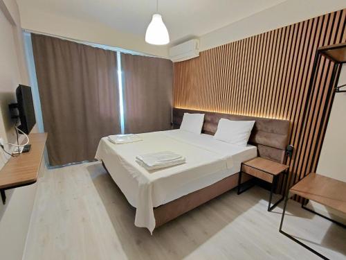 a bedroom with a large bed and a television at Moda Hotel in Kırklareli