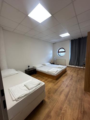 a room with two beds and a window at APARTMÁN CENTRUM Palackého in Trenčín