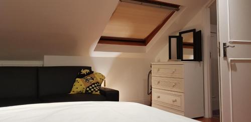 a bedroom with a bed and a dresser at 5 Tamar in Findon