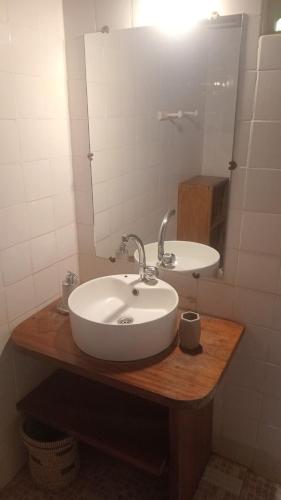 a bathroom with a white sink and a mirror at Bazouk Du Saloum Ecolodge Solidaire in Mar Lodj