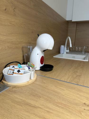 a kitchen counter with a plate of food and a lamp at MiLu Apartman in Győr
