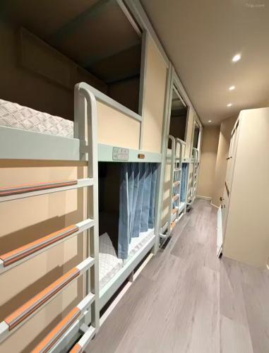 a row of bunk beds in a room at Moon Homestay in Jincheng