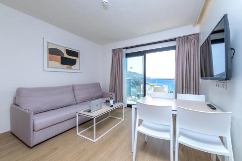 a living room with a couch and a table at Don Cesar Boutique Apartments in Benidorm