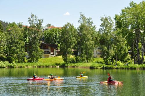 a group of people kayaking on a river at Casa al Lag - direkt am Laaxersee in Laax