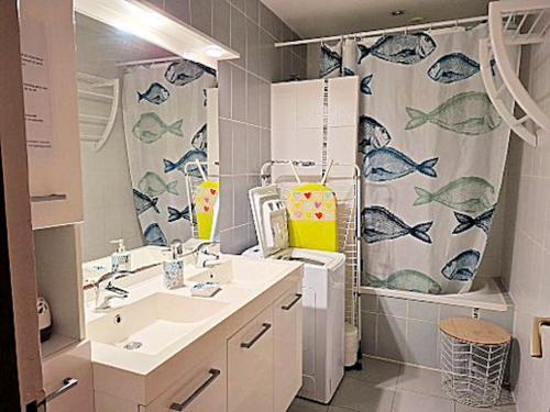 a bathroom with a sink and a shower curtain at LA BOUVIERE in Aulnat